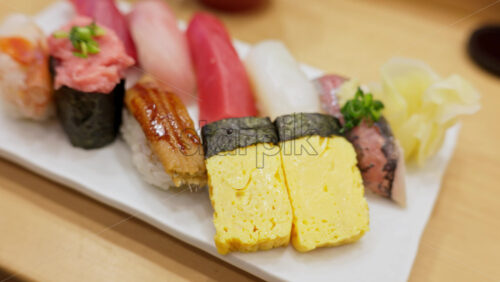 Close up of nigiri on a white plate at the Tsukiji Fish Market in Japan - Starpik Stock