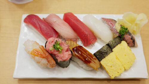 Close up of nigiri on a white plate at the Tsukiji Fish Market in Japan - Starpik Stock
