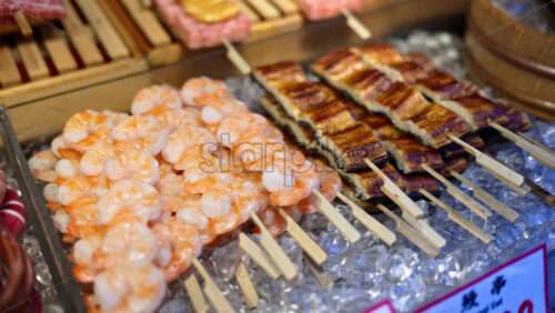 Close up of prawns on skewers at the Tsukiji Fish Market in Chuo, Tokyo, Japan - Starpik Stock