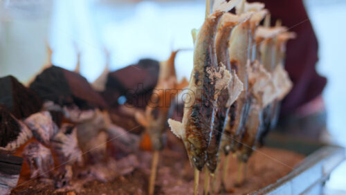 Close up of smoked fish at a street food market in Japan - Starpik Stock