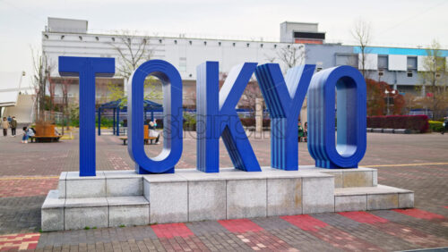 Tokyo writing in blue sign in Daiba, Japan in daylight - Starpik Stock