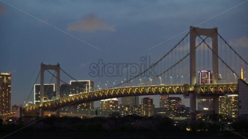 Video – Time lapse of the Rainbow Bridge and the skyline of Tokyo, Japan in the evening - Starpik Stock