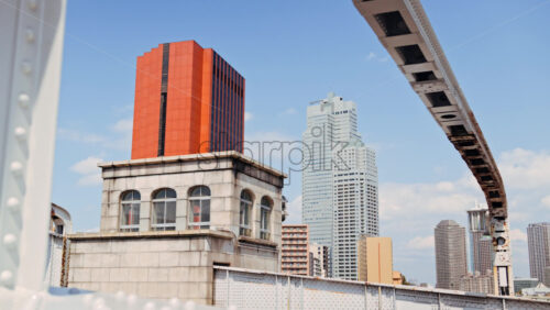 View of buildings in Chuo, Japan from the Kachidoki Bridge in daylight - Starpik Stock