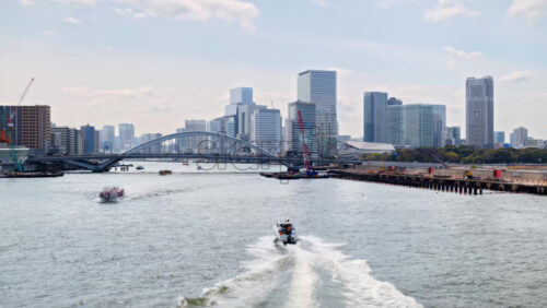 View of the Kachidoki Bridge with the buildings in Chuo, Japan on the background in daylight - Starpik Stock