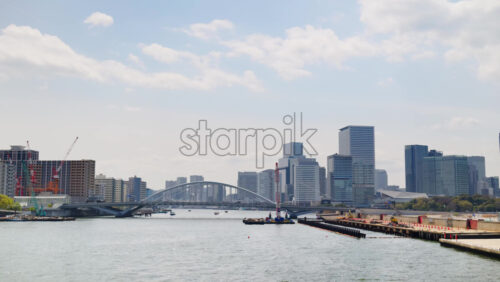 View of the Kachidoki Bridge with the buildings in Chuo, Japan on the background in daylight - Starpik Stock