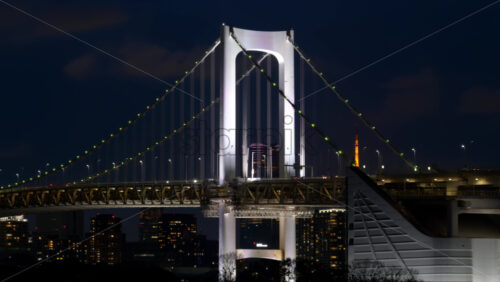 View of the Rainbow Bridge and the skyline of the city at night in Tokyo, Japan - Starpik Stock
