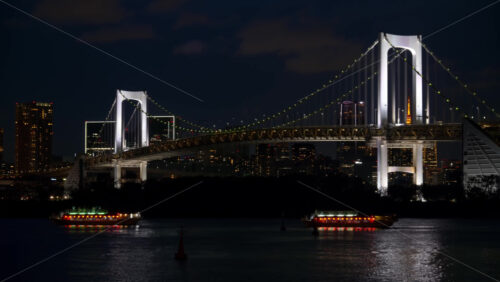 View of the Rainbow Bridge and the skyline of the city at night in Tokyo, Japan - Starpik Stock
