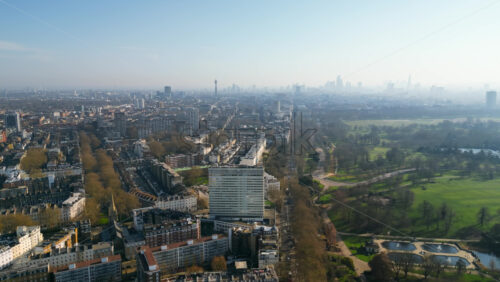 Aerial drone view of buildings surrounding Hyde Park in London, England in daylight - Starpik Stock