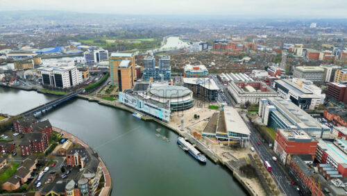 Aerial drone view of cars driving over the buildings surrounding River Lagan - Starpik Stock
