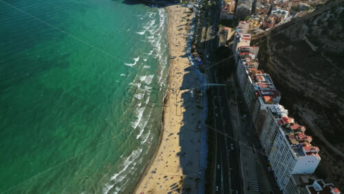 Aerial drone view of cars moving along the coastline in Alicante, Spain in daylight - Starpik Stock