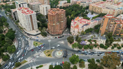 Aerial drone view of cars moving on the streets between the buildings in Valencia, Spain in daylight - Starpik Stock