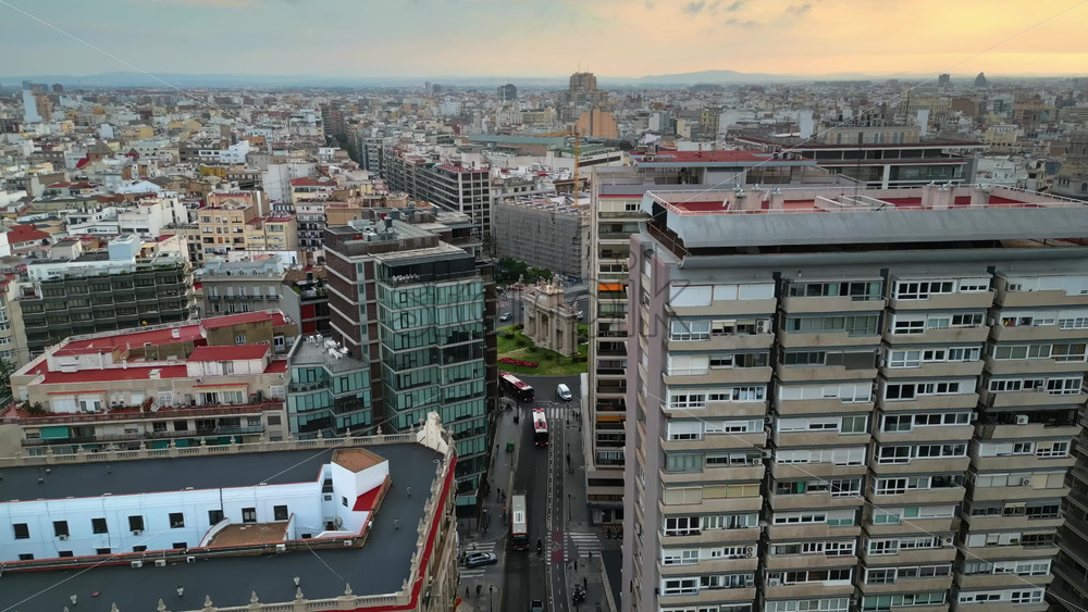 Aerial drone view of cars moving on the streets between the buildings, near Porta De La Mar in Valencia, Spain in daylight - Starpik Stock