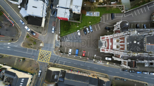Aerial drone view of cars moving on the streets near the St Anne’s Church Shandon Bells and Tower in Cork, Ireland - Starpik Stock