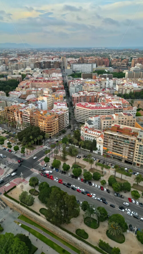 Aerial drone view of cars moving on the streets of Valencia, Spain in daylight. Vertical - Starpik Stock