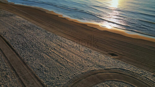 Aerial drone view of palm trees on the beach in Alicante, Spain at sunset - Starpik Stock