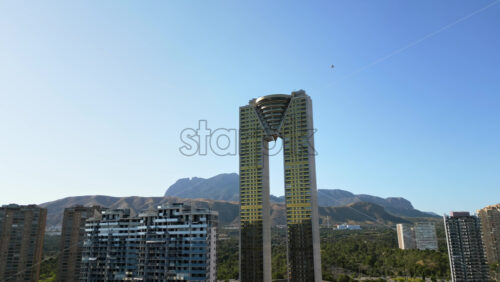Aerial drone view of the Intempo skyscraper building in Benidorm, Alicante, Spain in daylight - Starpik Stock