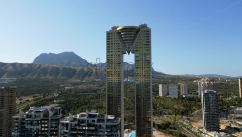 Aerial drone view of the Intempo skyscraper building in Benidorm, Alicante, Spain in daylight - Starpik Stock