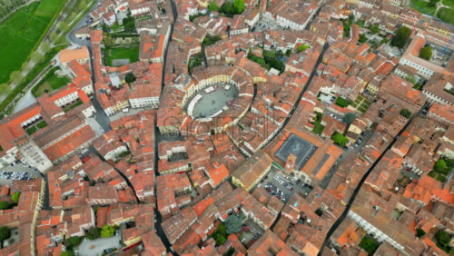 Aerial drone view of the Lucca city on the Serchio river in Italy’s Tuscany region - Starpik Stock