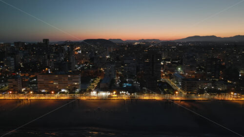 Aerial drone view of the Mediterranean Sea and the Alicante city in Spain at sunset - Starpik Stock