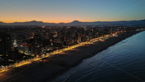 Aerial drone view of the Mediterranean Sea and the Alicante city in Spain at sunset - Starpik Stock