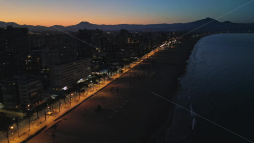 Aerial drone view of the Mediterranean Sea and the Alicante city in Spain at sunset - Starpik Stock