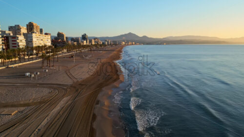 Aerial drone view of the Mediterranean Sea and the city of Alicante, Spain at sunset - Starpik Stock