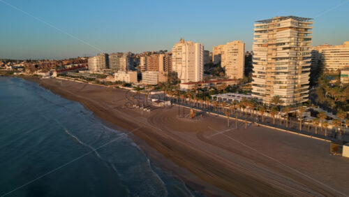 Aerial drone view of the Mediterranean Sea and the city of Alicante, Spain at sunset - Starpik Stock