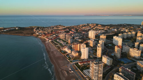 Aerial drone view of the Mediterranean Sea and the city of Alicante, Spain at sunset - Starpik Stock