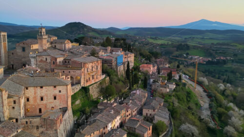 Aerial drone view of the Montepulciano medieval hilltop town in Tuscany, Italy, surrounded by vineyards - Starpik Stock