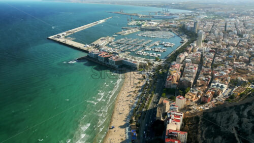Aerial drone view of the Port of Alicante and the buildings in the city in daylight - Starpik Stock