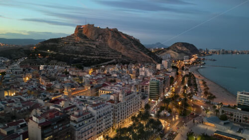 Aerial drone view of the Santa Barbara Castle on the coast of Alicante, Spain at sunset - Starpik Stock