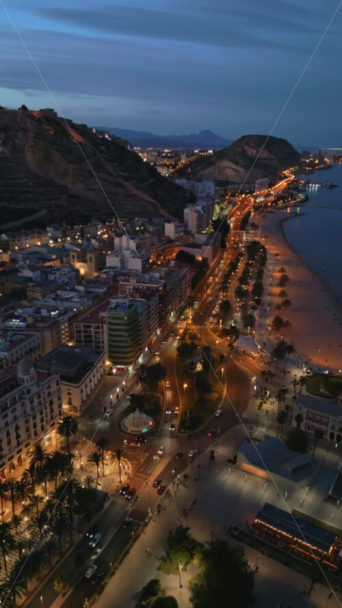 Aerial drone view of the Santa Barbara Castle on the coast of Alicante, Spain at sunset. Vertical - Starpik Stock