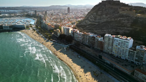 Aerial drone view of the Santa Barbara Castle on the coast of Alicante, Spain with the city and the sea in daylight - Starpik Stock