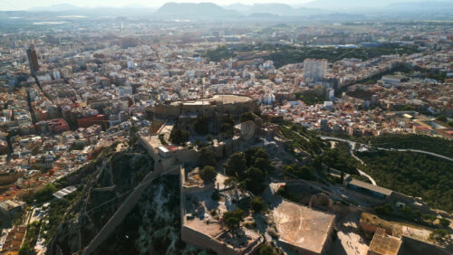 Aerial drone view of the Santa Barbara Castle on the coast of Alicante, Spain with the city on the background - Starpik Stock