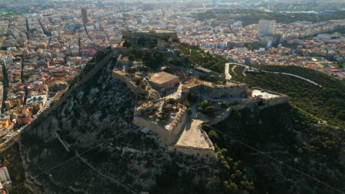 Aerial drone view of the Santa Barbara Castle on the coast of Alicante, Spain with the city on the background - Starpik Stock