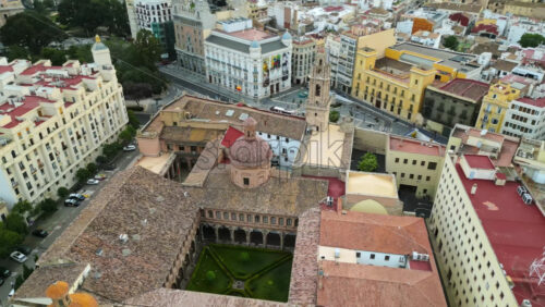 Aerial drone view of the Santa Catalina Church surrounded by buildings in Valencia, Spain - Starpik Stock