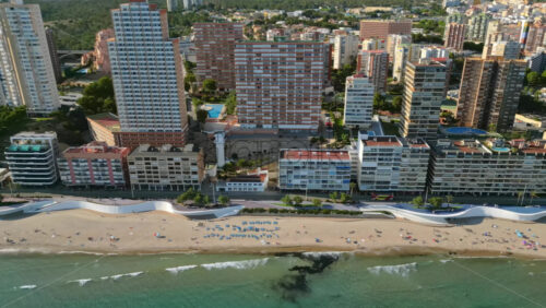 Aerial drone view of the buildings along the coastline and the sea in Benidorm, Spain in daylight - Starpik Stock