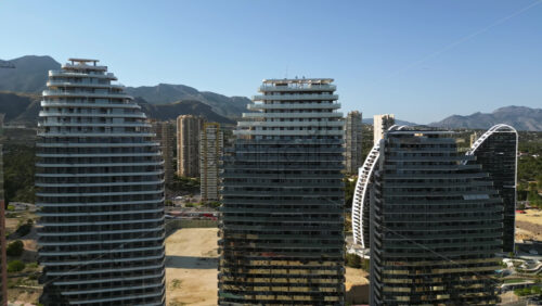 Aerial drone view of the buildings along the coastline in Benidorm, Spain in daylight - Starpik Stock