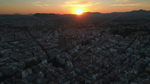 Aerial drone view of the buildings in Alicante, Spain at sunset - Starpik Stock