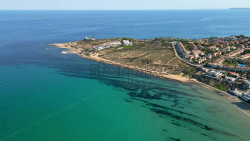 Aerial drone view of the coastline of Alicante, Spain in daylight - Starpik Stock