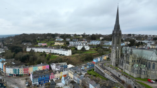 Aerial drone view of the colourful houses surrounding the St Colman’s Cathedral in Cork, Ireland - Starpik Stock
