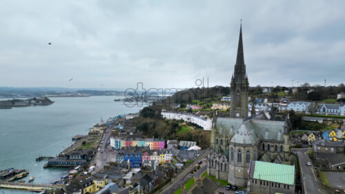 Aerial drone view of the colourful houses surrounding the St Colman’s Cathedral in Cork, Ireland - Starpik Stock
