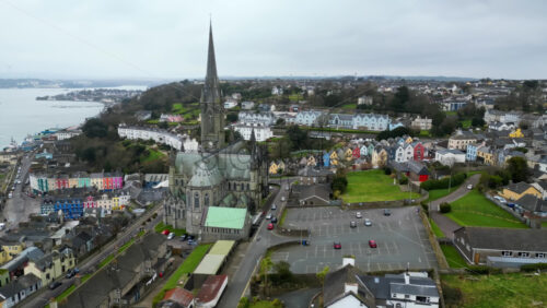 Aerial drone view of the colourful houses surrounding the St Colman’s Cathedral in Cork, Ireland - Starpik Stock