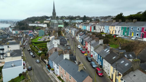 Aerial drone view of the colourful houses surrounding the St Colman’s Cathedral in Cork, Ireland - Starpik Stock
