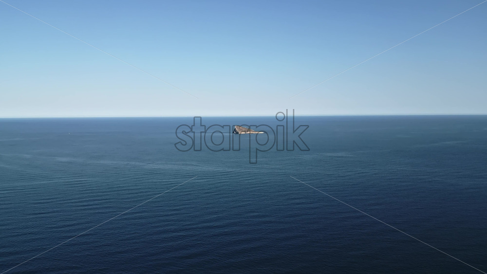 Aerial drone view of the small Benidorm Island and nature reserve on the Mediterranean Sea in Benidorm, Spain - Starpik Stock