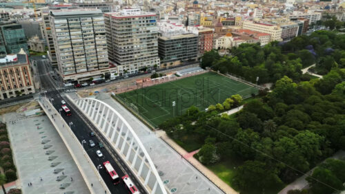 Cars and public transportation moving on the Exhibition Bridge near the Mestalla Stadium, and the Turia Gardens Park in Valencia, Spain - Starpik Stock