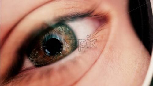 Video - Close up macro kid eye with big retina and eyebrows, wearing glasses