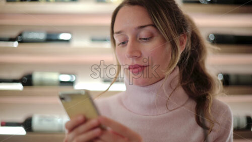 Video - Brunette woman scrolling on her phone at a restaurant