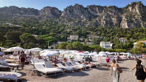 Video - Beaulieu-sur-Mer, France - July 5, 2024: People swimming and relaxing at the Petite Afrique Beach