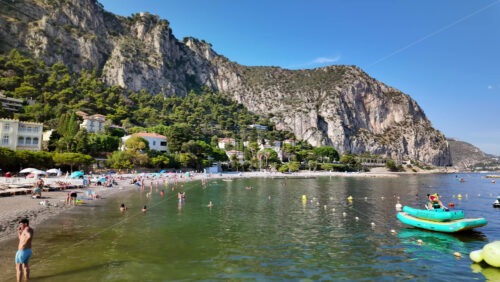 Video - Beaulieu-sur-Mer, France - July 5, 2024: People swimming and relaxing at the Petite Afrique Beach